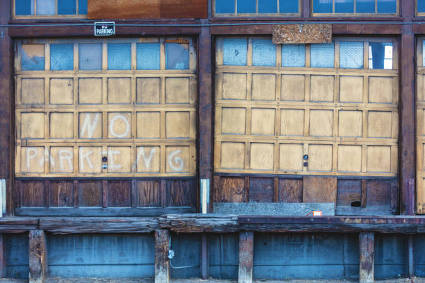 istock Rustic Abandoned Warehouse Exterior Garage Doors and Dock Background 1009838876