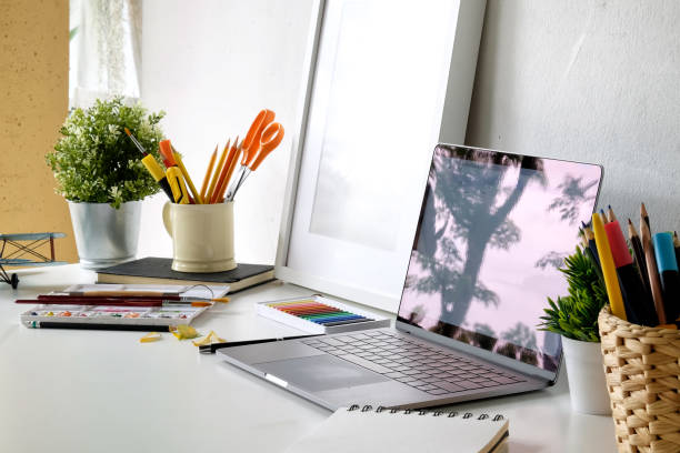 istock Office desk laptop and mockup poster. 1009841322