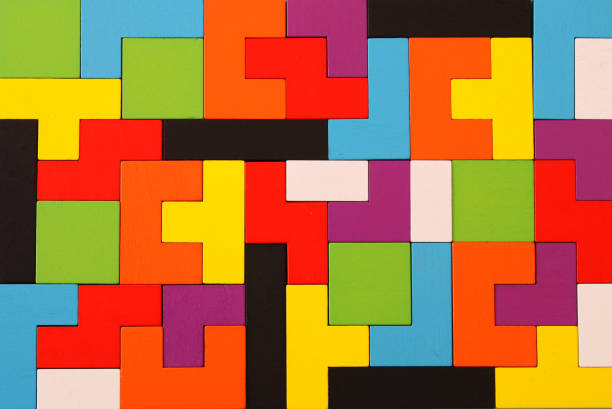 istock A colorful square tangram puzzle, over wooden table. 1009844082