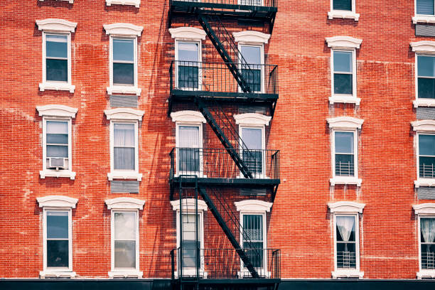istock Old red brick building with fire escapes, New York City. 1009847122