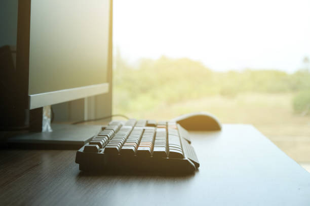 istock Office workplace with computer desktop  and keyboard on wood table by the window 1009849560