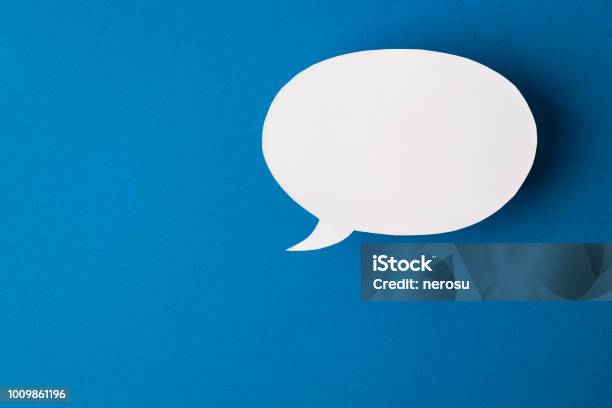 Speech Bubble On Blue Background Stock Photo - Download Image Now - Discussion, Speech Bubble, Talking