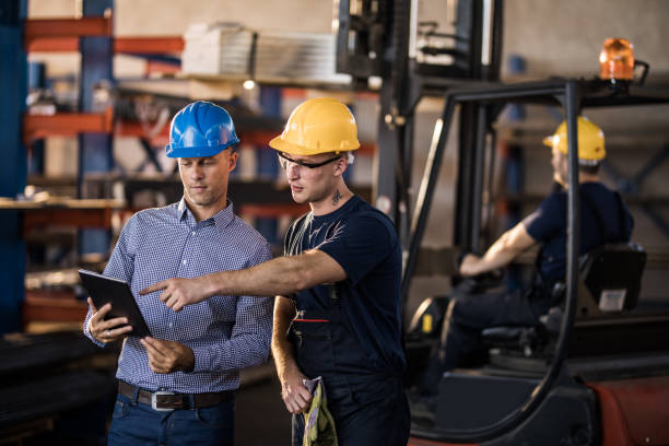 istock Young manual worker and manager working on digital tablet in a warehouse. 1009864940