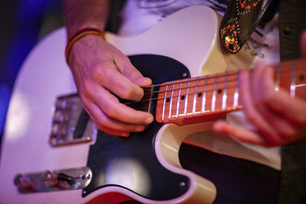 istock Male hands playing electric guitar 1009865244