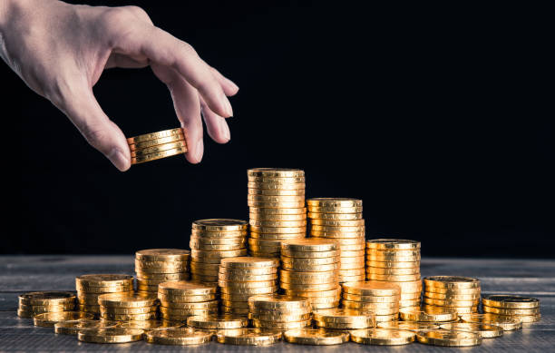 istock A large amount of gold coins with black back 1009865306