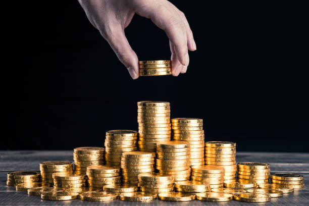 istock A large amount of gold coins with black back 1009865310