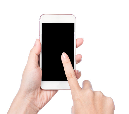 Closeup shot of a woman typing on mobile phone isolated on white background. Girl's hand holding a modern smartphone and pointing with figer. Blank screen to put it on your own webpage or message.