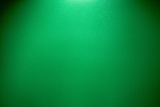 istock Abstract green background and black vignette border frame 1009885782