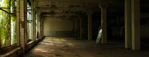 istock Industrial interior at the old electronic devices factory with big windows and empty floor. 1009886062