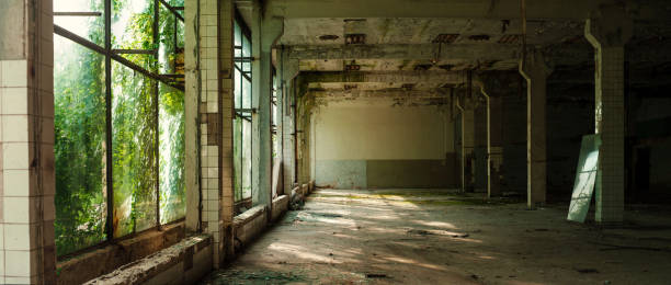 istock Industrial interior at the old electronic devices factory with big windows and empty floor. 1009886068