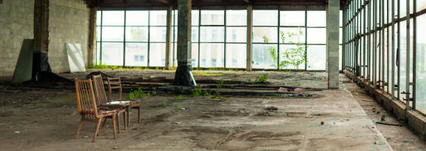 istock Industrial interior at the old electronic devices factory with big windows and empty floor. 1009886090