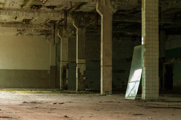 istock Industrial interior at the old electronic devices factory with big windows and empty floor. 1009886124