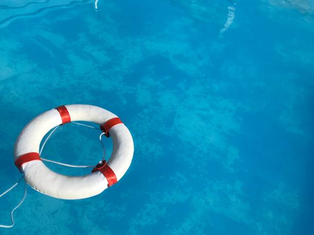 istock Life buoy floating in the swimming pool 1009886398