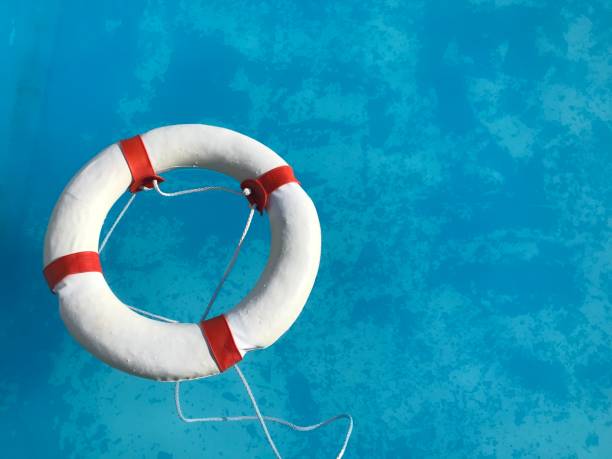 istock Life buoy floating in the swimming pool 1009886440