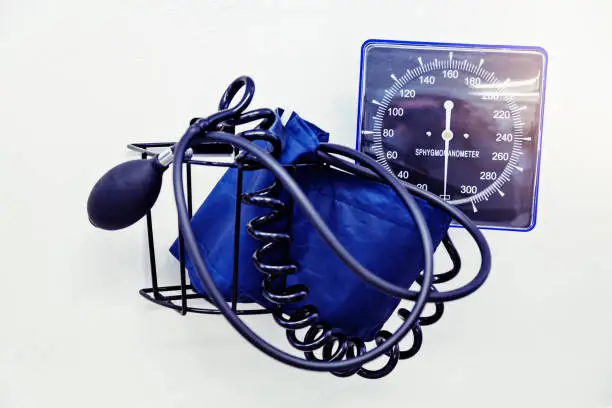 A device to measure blood pressure - a sphygmomanometer - with cuff, pump, tubing and dial.