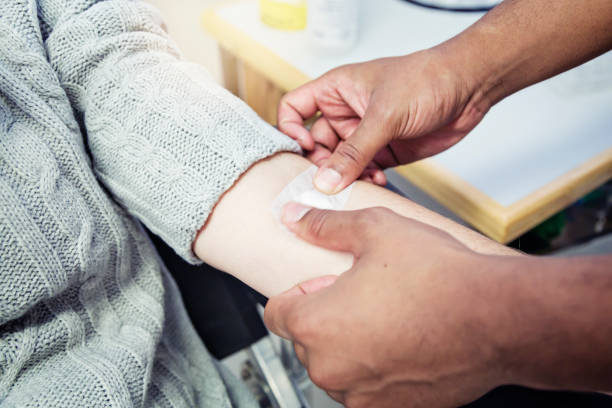 istock Taping up the site where blood has been taken 1009889312