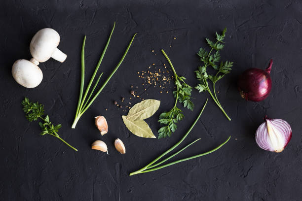 istock Garlic onion and parsley on a black background 1009892076