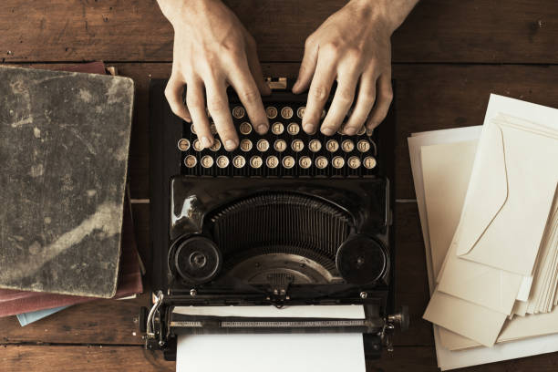 istock Young man's hands typing on an antique vintage typewriter 1009892144