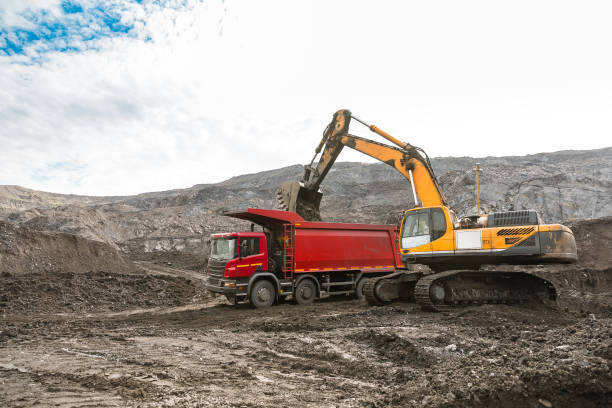 istock Large quarry dump truck. Loading the rock in dumper. Loading coal into body truck. Production useful minerals. Mining truck mining machinery, to transport coal from open-pit as the coal production. 1009906246