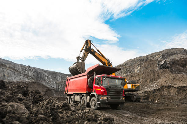 istock Large quarry dump truck. Loading the rock in dumper. Loading coal into body truck. Production useful minerals. Mining truck mining machinery, to transport coal from open-pit as the coal production. 1009906276