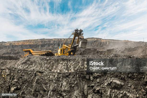 Large Quarry Dump Truck Loading The Rock In Dumper Loading Coal Into Body Truck Production Useful Minerals Mining Truck Mining Machinery To Transport Coal From Openpit As The Coal Production Stock Photo - Download Image Now