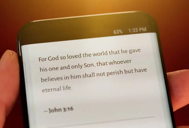 Photo of Bible text from Gospel of St John on phone screen