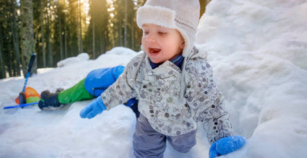 istock Baby boy playing in snow 1009907204