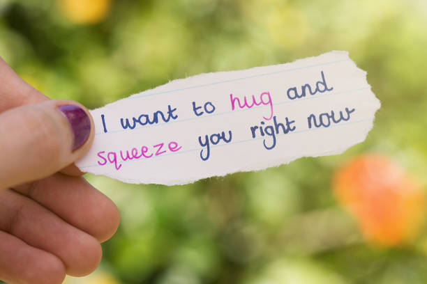 istock Hand-written flirtatious love note held by woman 1009910072