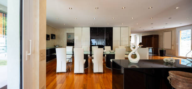 istock Dining room with leather chairs, glass table and parquet 1009910846