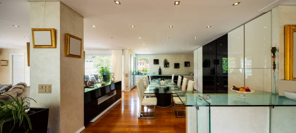 istock Dining room with leather chairs, glass table and parquet 1009910866