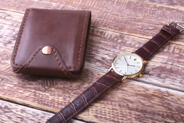 istock Men's accessories with brown leather wallet, belt and watch. 1009913354