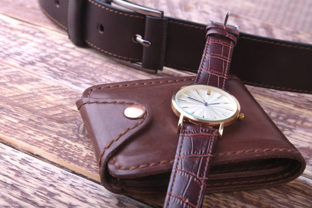 istock Men's accessories with brown leather wallet, belt and watch. 1009913588