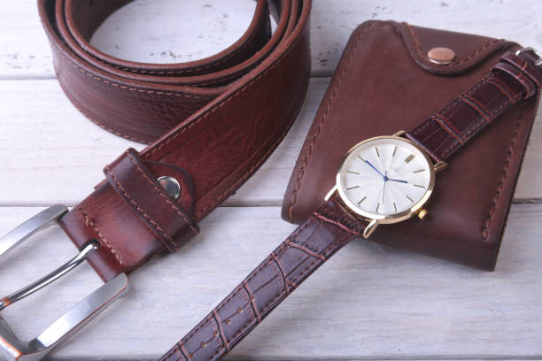 istock Men's accessories with brown leather wallet, belt and watch. 1009913806