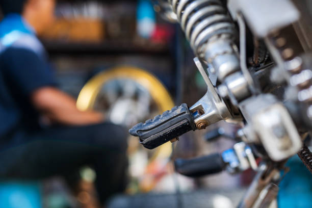 istock Automobile mechanic repairing motorcycle 1009913916