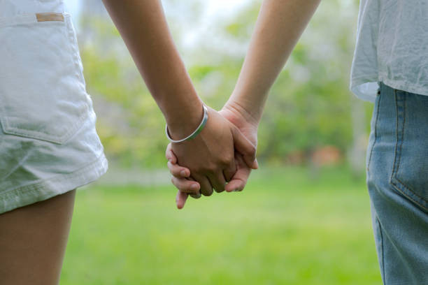 istock Couples holding hands in beautiful park 1009917160