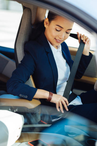 istock Positive young woman driving safe 1009922490