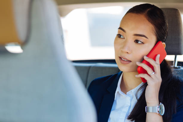 istock Smart young woman having a phone conversation 1009925560