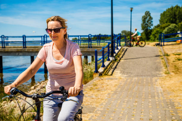 istock Woman riding bike at seaside 1009926870