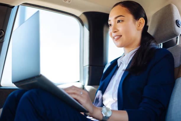 istock Delighted positive woman working from the car 1009929524