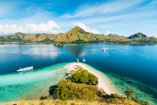 Top view of Kelor Island in an afternoon before sunset with turquoise sea and tourist boats, Komodo Island (Komodo National Park), Labuan Bajo, Flores, Indonesia