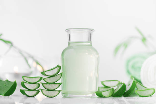 Fresh aloe vera juice and aloe vera leaf for spa background.