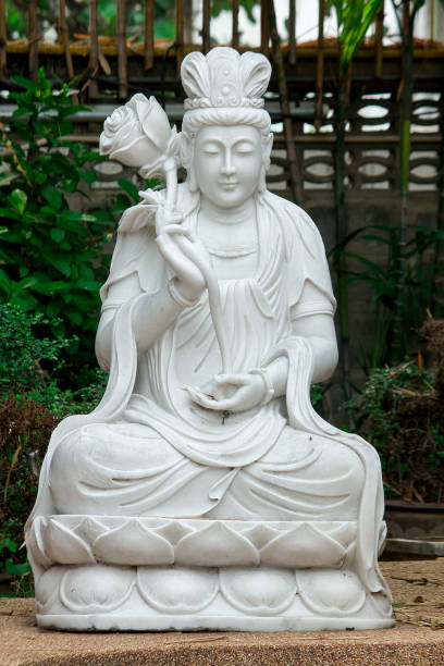 istock Statue of Guan Yin carved from marble. 1009934420