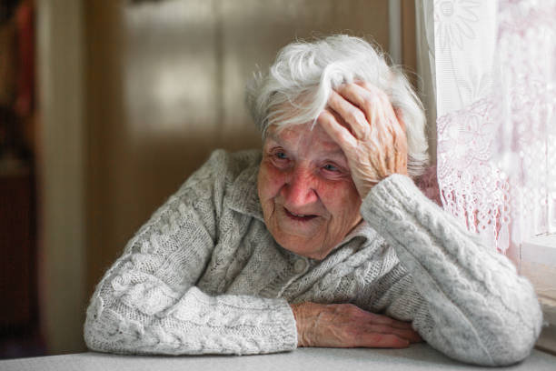 istock Elderly woman sitting at the table. 1009937044
