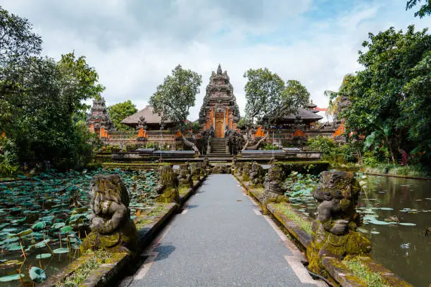 Beautiful symmetrical view of Pura Taman Saraswati or Saraswati Temple surrounded by lotus pond and Plumeria trees in Ubud, Bali, Indonesia