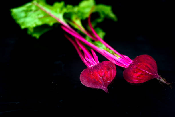Beetroot cut in half on a black background, place for text, healthy food