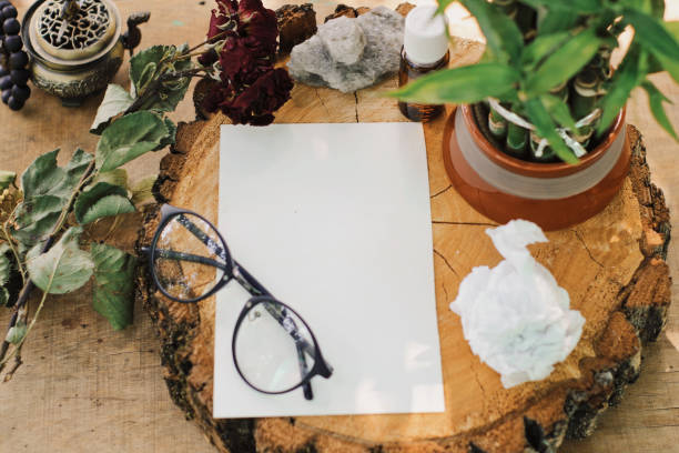 Blank photo frame with eyeglasses and flowers