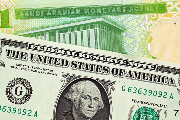 istock Saudi One Riyal Note With An American One Dollar Bill 1009952960