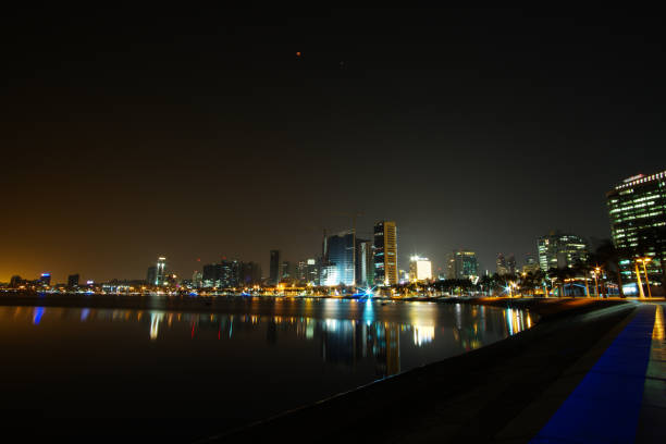 istock Long exposure night wide angle view of Marginal de Luanda with full moon and Mars during total lunar eclipse 1009955894