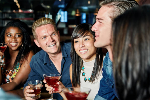 istock Happy group of young adults enjoying a night out 1009956470