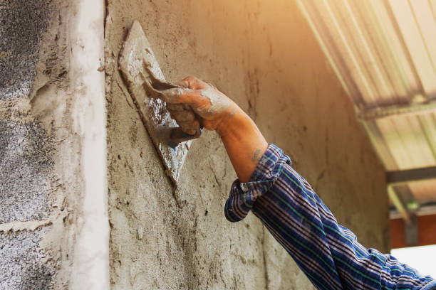 istock closeup hand of worker are plastering on wall 1009964048